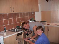 Maire and Glen Install a new kitchen in the school.